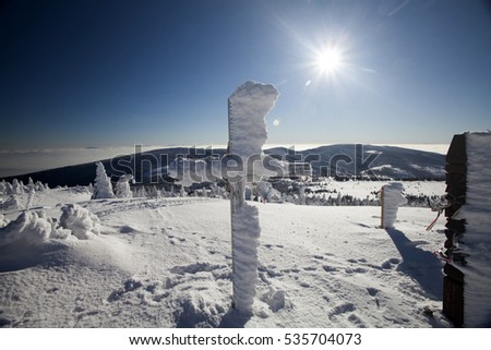Frozen crosses in winter landscape