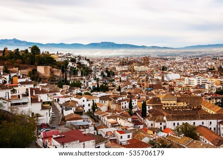 Granada, Spain. Aerial view of Granada - famous city in Andalusia, Spain in the morning with mountains at the background. It is a UNESCO World Heritage Site and a major touristic attraction