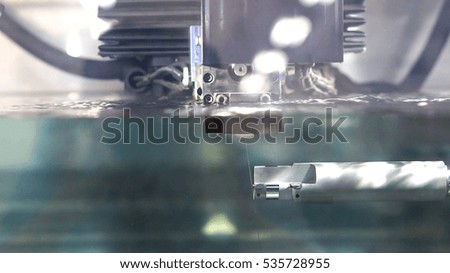 industrial machine and factory robot concept - Close up precision factory robot machine process under water in car parts factory and copy space