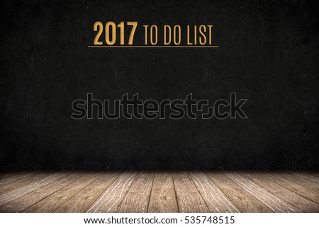 2017 to do list gold text on blackboard wall on wood plank floor,New year business presentation planning,mock up wall for adding your design or text.
