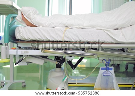 Wrapped in a blanket patient in a hospital bed. Royalty-Free Stock Photo #535752388