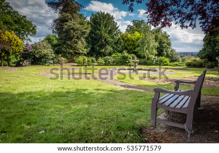 Empty bench In a park in spring, England Royalty-Free Stock Photo #535771579