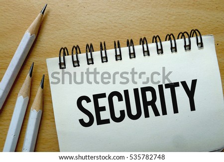 Security text written on a notebook with pencils
