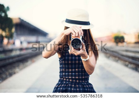 The hipster woman take a photo for travel on the street