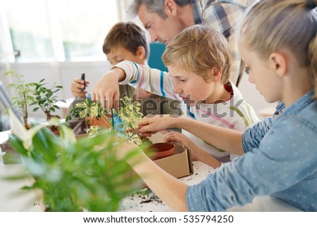 Teacher with kids in biology class learning about plants Royalty-Free Stock Photo #535794250
