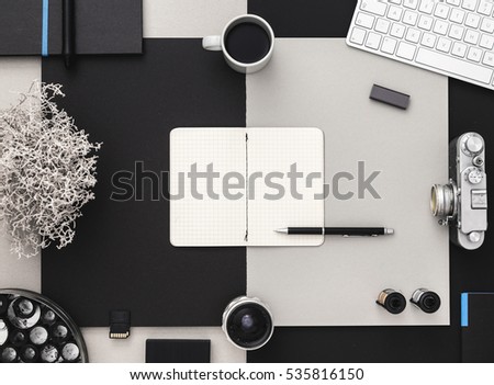Workspace of photographer. Photographer's table with tablet , vintage camera, coffee and keyboard in black and grey.Creative workspace. Ideas and inspiration. Flat lay.
