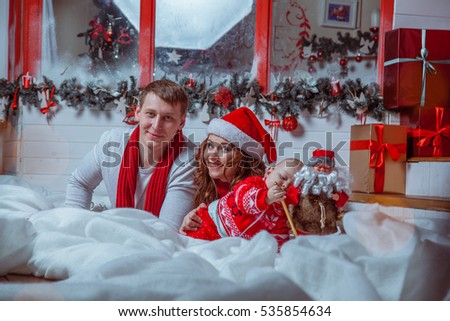 Young happy family with a child in the house of Santa Claus