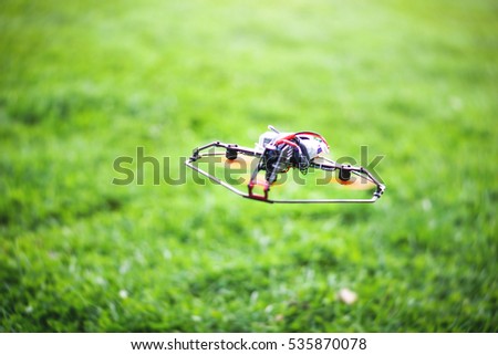 Flying smart drone on a background of green grass - Innovation and technology concept