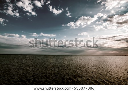 Amazing abstract view of clear sea landscape with cloudy sky as a background Sunset time. Baku, Azerbaijan