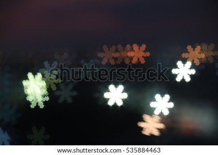 Abstract of Christmas background of de-focused lights with decorated tree and snow flake