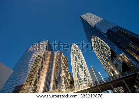Skyscrapers with glass facade. Modern buildings in Paris business district. Concepts of economics, financial, future.  Copy space for text. Dynamic composition. Toned