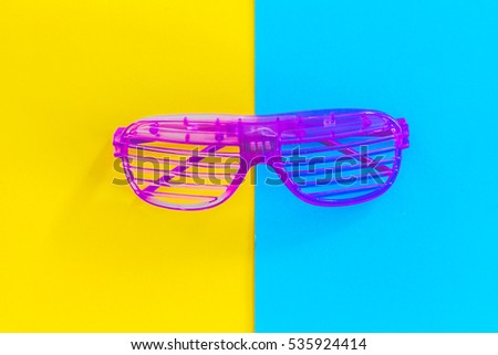 Disco party glasses on colourful background