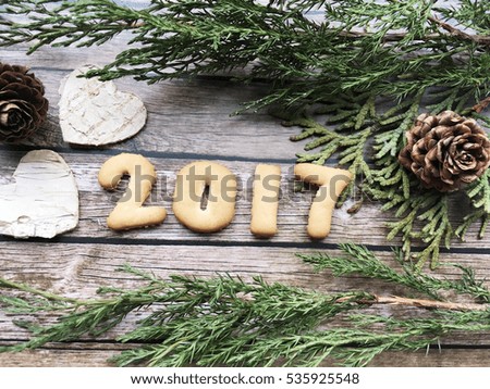 2017 date. 2017 cookies date on wooden background with white cedar tree. 