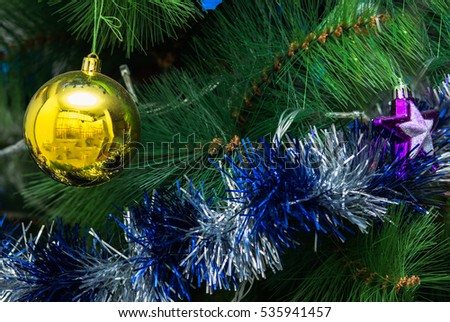Christmas tree decoration tinsel   and bauble background.
