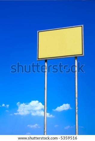 Blank yellow sign against deep blue sky background