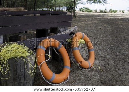 lifesaver,life buoy and ropes on the beach.life ring