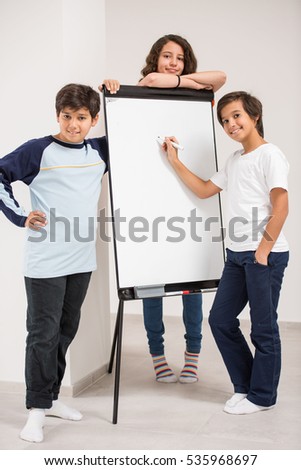 Group of kids holding white board as copy space