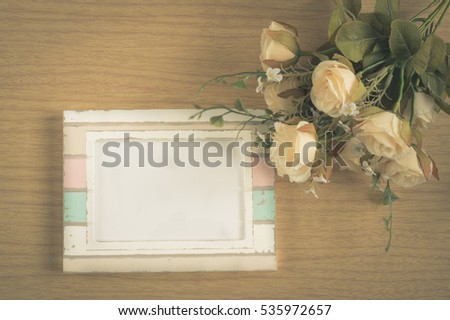 Photo frame with rose flowers,vintage filtered.