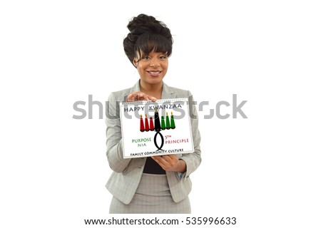 Happy Kwanzaa Purpose (Nia) Calendar Seventh Principle Kinara Candle holder 
held by African American Business Woman looking at camera smiling isolated 
on white background