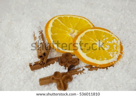 dried slice of orange, cinnamon stick and star anise over white background