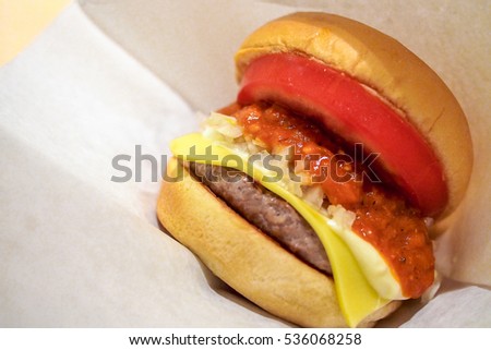Delicious Burger with tomato, chili, dice onions, cheese and beef patty. Japanese Style food.