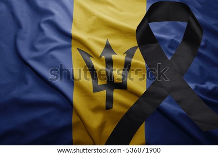 waving national flag of barbados with black mourning ribbon