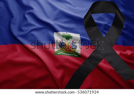 waving national flag of haiti with black mourning ribbon