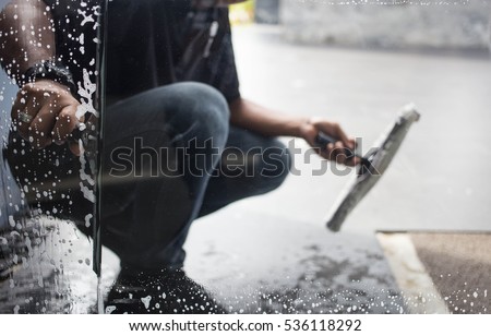 Cleaning windows with a squeegee Royalty-Free Stock Photo #536118292
