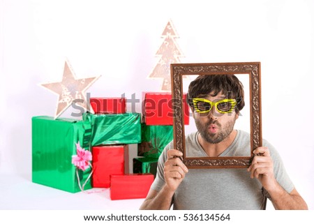 Portrait of a crazy man holding picture frame