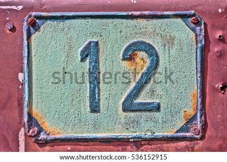 The old house number 12 on the farmhouse.