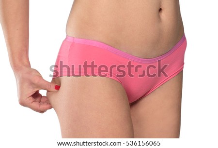 woman pinching her fat ass isolated on white background