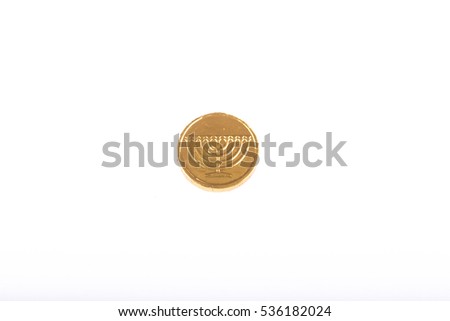 Image of jewish holiday Hanukkah, one chocolate coin on white background (top view)