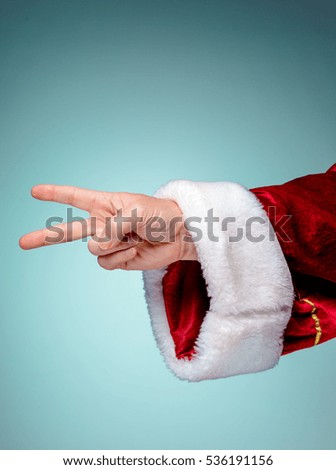 Santa Claus hand showing sign victory with thumbs up