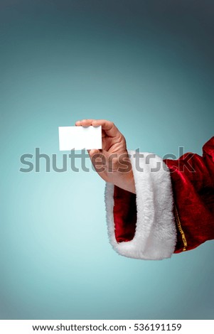Photo of Santa Claus hand with a business card