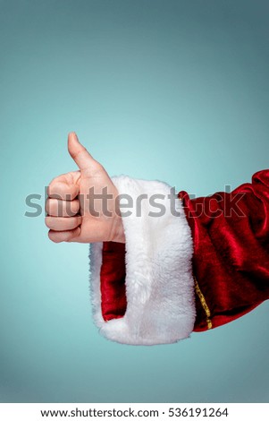 Santa Claus hand showing thumbs up