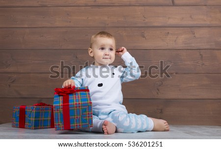 boy sitting and waiting for their Christmas presents