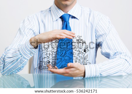 Businessman at table presenting business sketched plan in palm