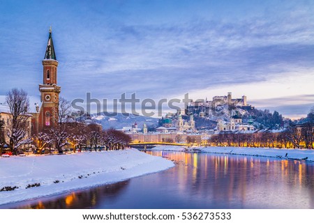Classic view of the historic city of Salzburg with famous Festung Hohensalzburg and Salzach river illuminated in beautiful twilight during scenic Christmas time in winter, Salzburger Land, Austria Royalty-Free Stock Photo #536273533