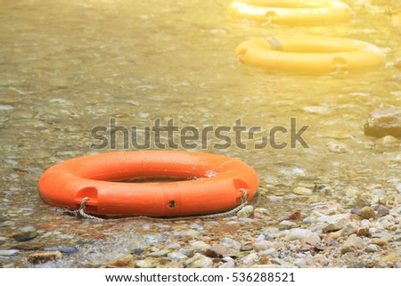 life preserver float in the river. Artificial light was added on the top right corner for 'HOPE and SAVE concept'.