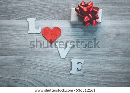LOVE letters, cardboard heart and gift  box  with red bow. concept for Valentine's day, romantic anniversary,love.