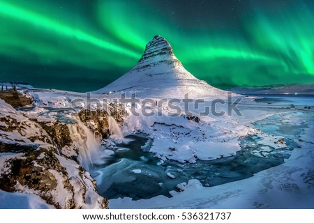 northern lights appear over Mount Kirkjufell in Iceland. Royalty-Free Stock Photo #536321737