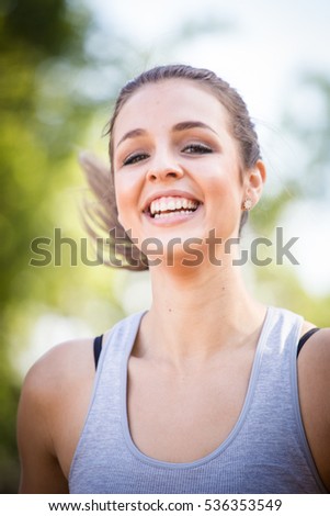 Female fitness model being active outside in a suburban area