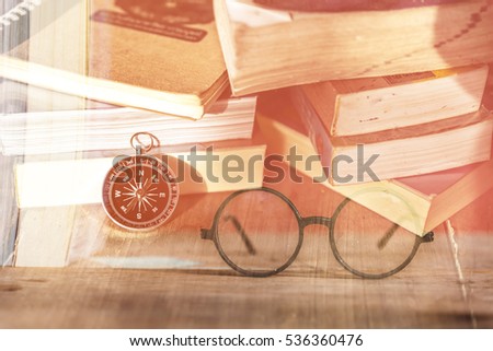 Compass on open old book