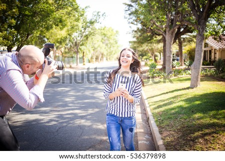 Photographer taking pictures of a model during a stock photography shoot