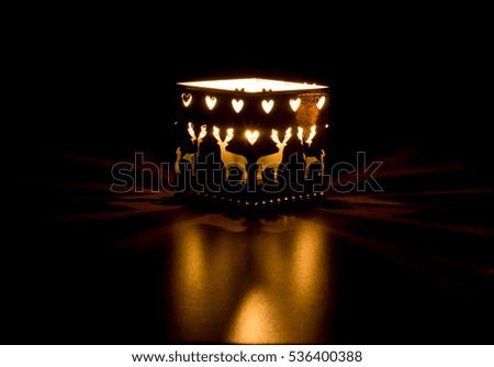 Ornamental Christmas lantern with a glowing candle 