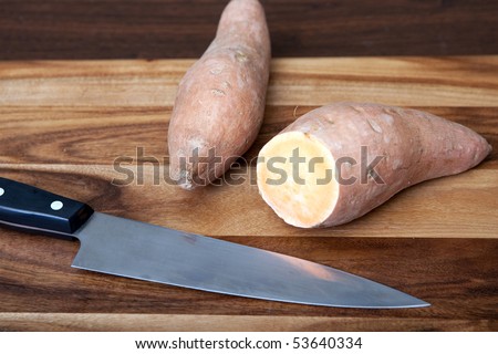 One cut yam, one uncut with knife