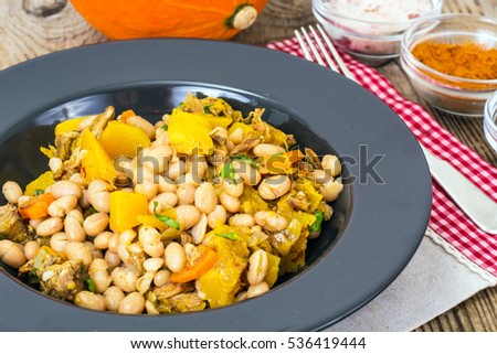 White beans stewed with meat and vegetables. Studio Photo