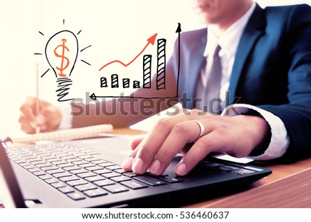 Businessman is writing ideas on a notebook.