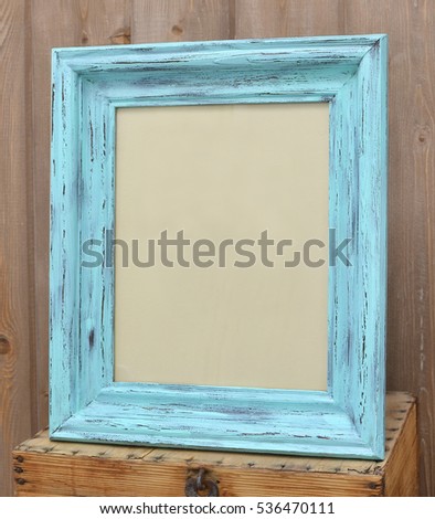 Beautiful wooden textured frame shabby turquoise color on wooden brown background. The basis for greeting cards. Grunge, rustic, romantic, Provence, crafts, advertisement, header, name.