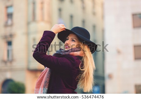 Young beautiful fashionable woman posing on the street.